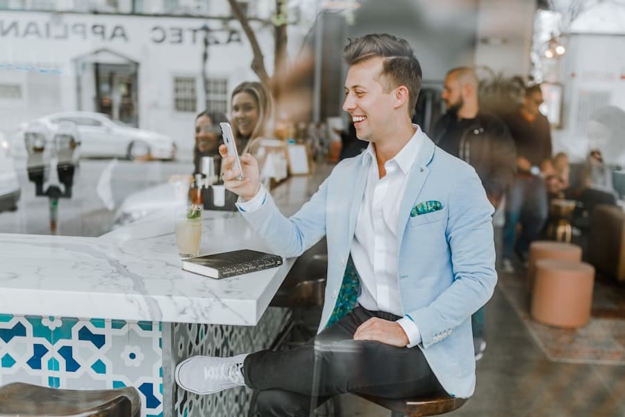 A client smiling while viewing photos on his phone